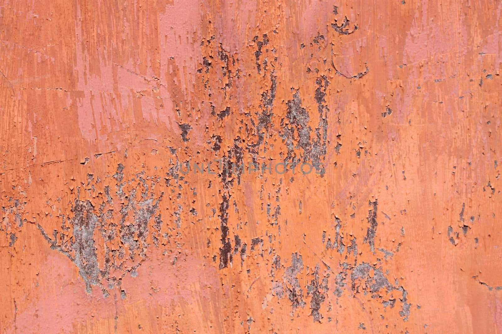 orange scratched metal surface with peeling paint