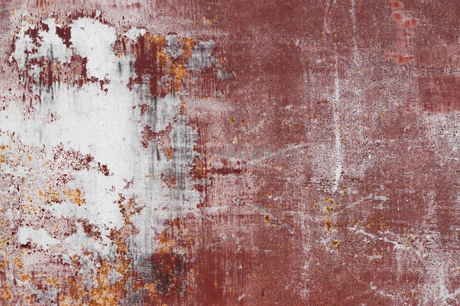 red scratched metal surface with peeling paint
