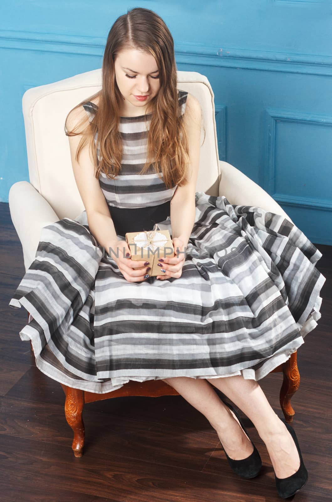 Young woman excited opening the present box. top view