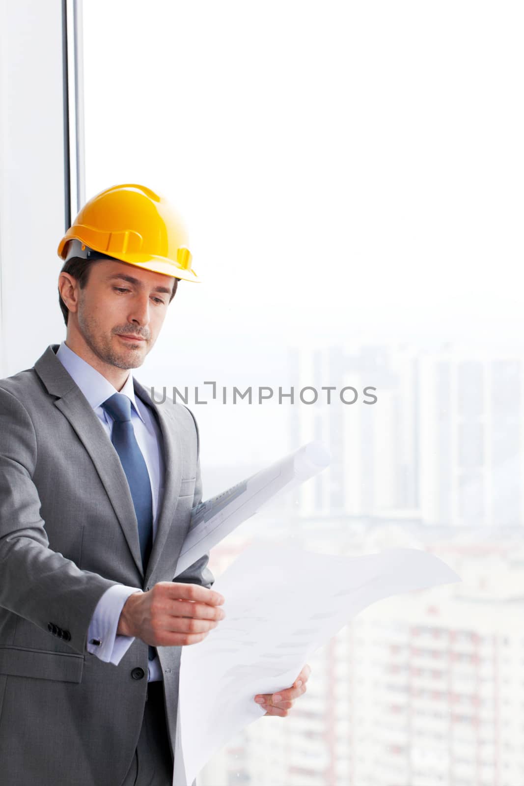 businessman in construction helmet by ALotOfPeople