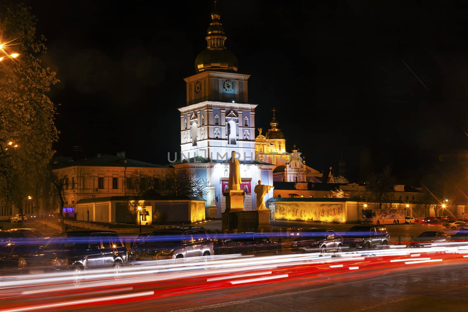 Saint Michael Monastery Cathedral Steeples Spires Tower Night Traffic Lights Facade Kiev Ukraine.  Saint Michael's is a functioning Greek Orthordox Monasatery in Kiev.  The original monastery was created in the 1100s but was destroyed by the Soviet Union in the 1930s.  St. Michaels was reconstructed after Ukrainian independencein 1991 and reopened in 1999.