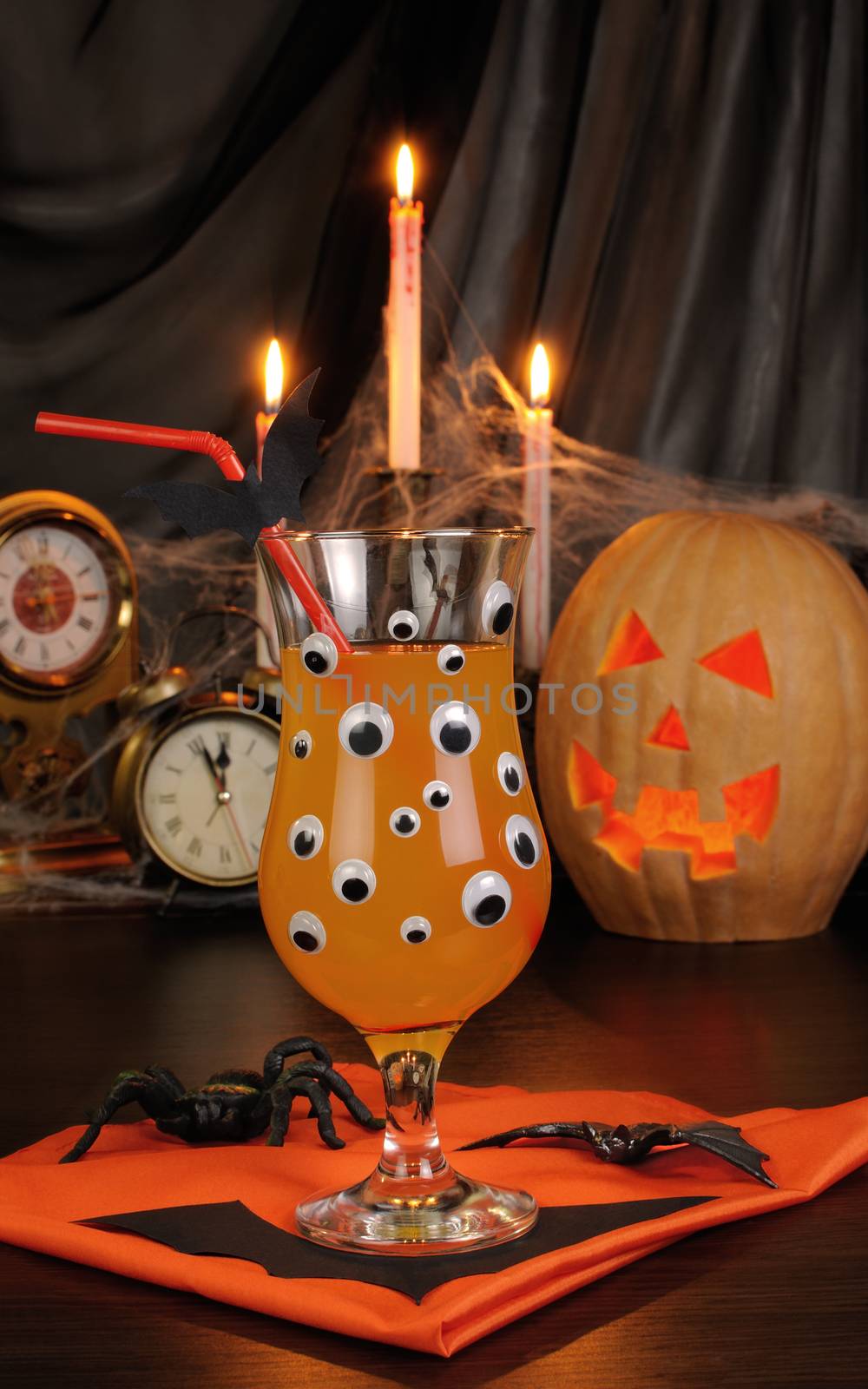 A glass of drink on the table in honor of Halloween