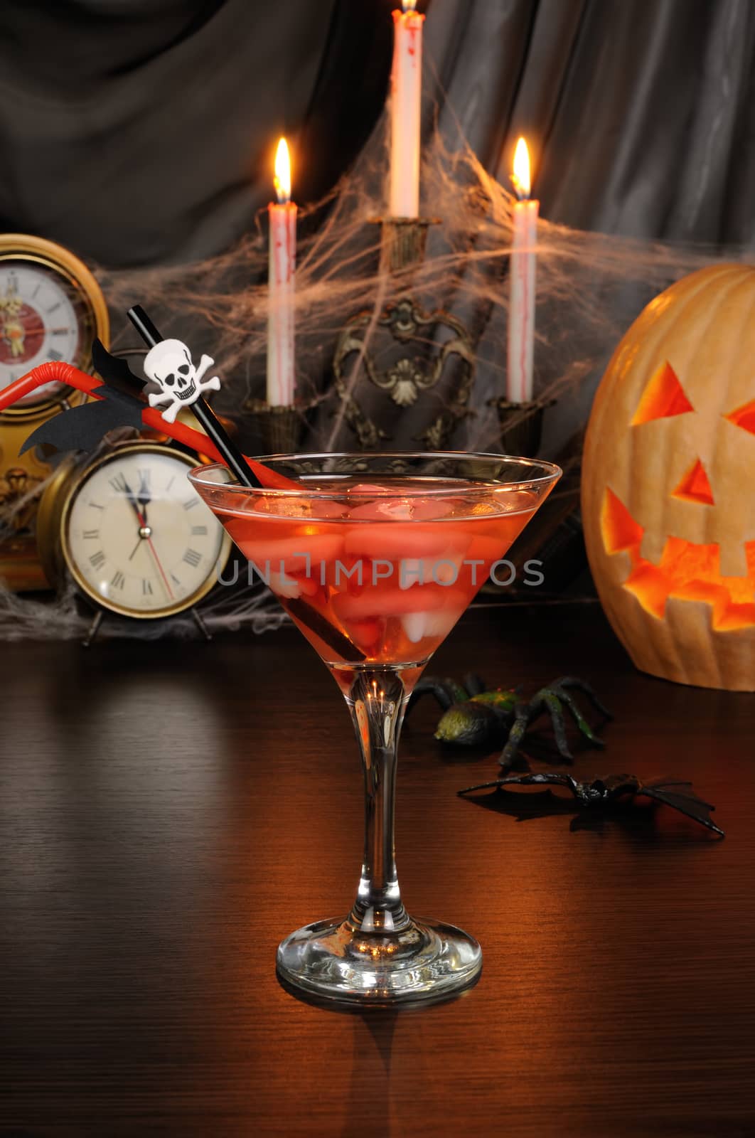 Cocktail glass filled with vampire teeth on the table for Halloween