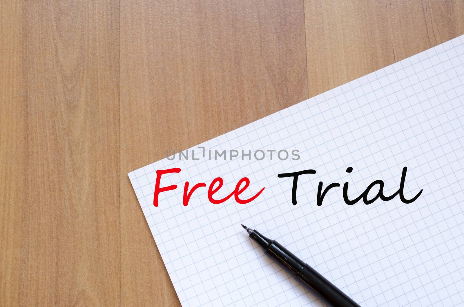 White blank notepad on office wooden table Free Trial concept