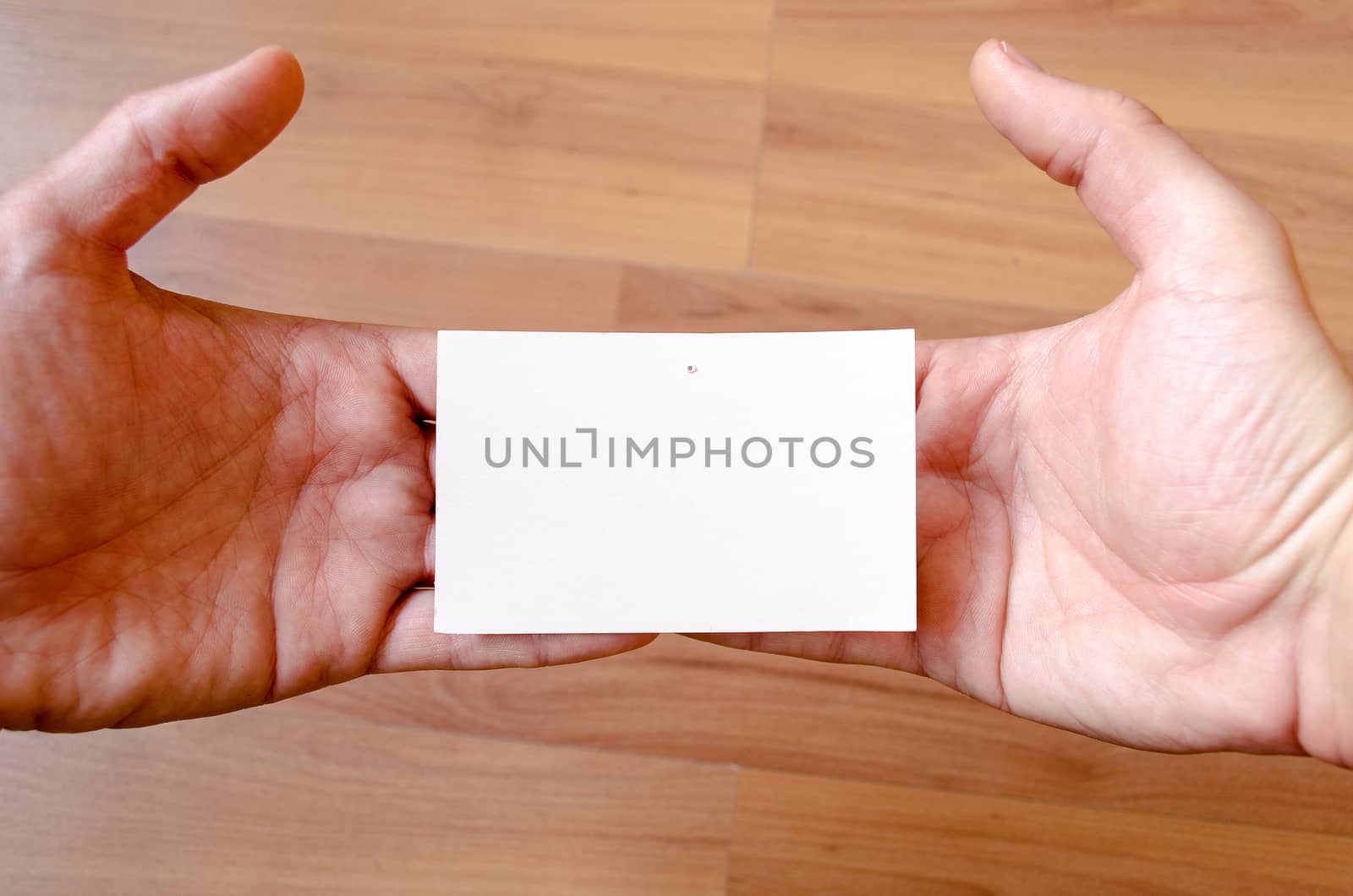 Man hands hold note with wood table office background
