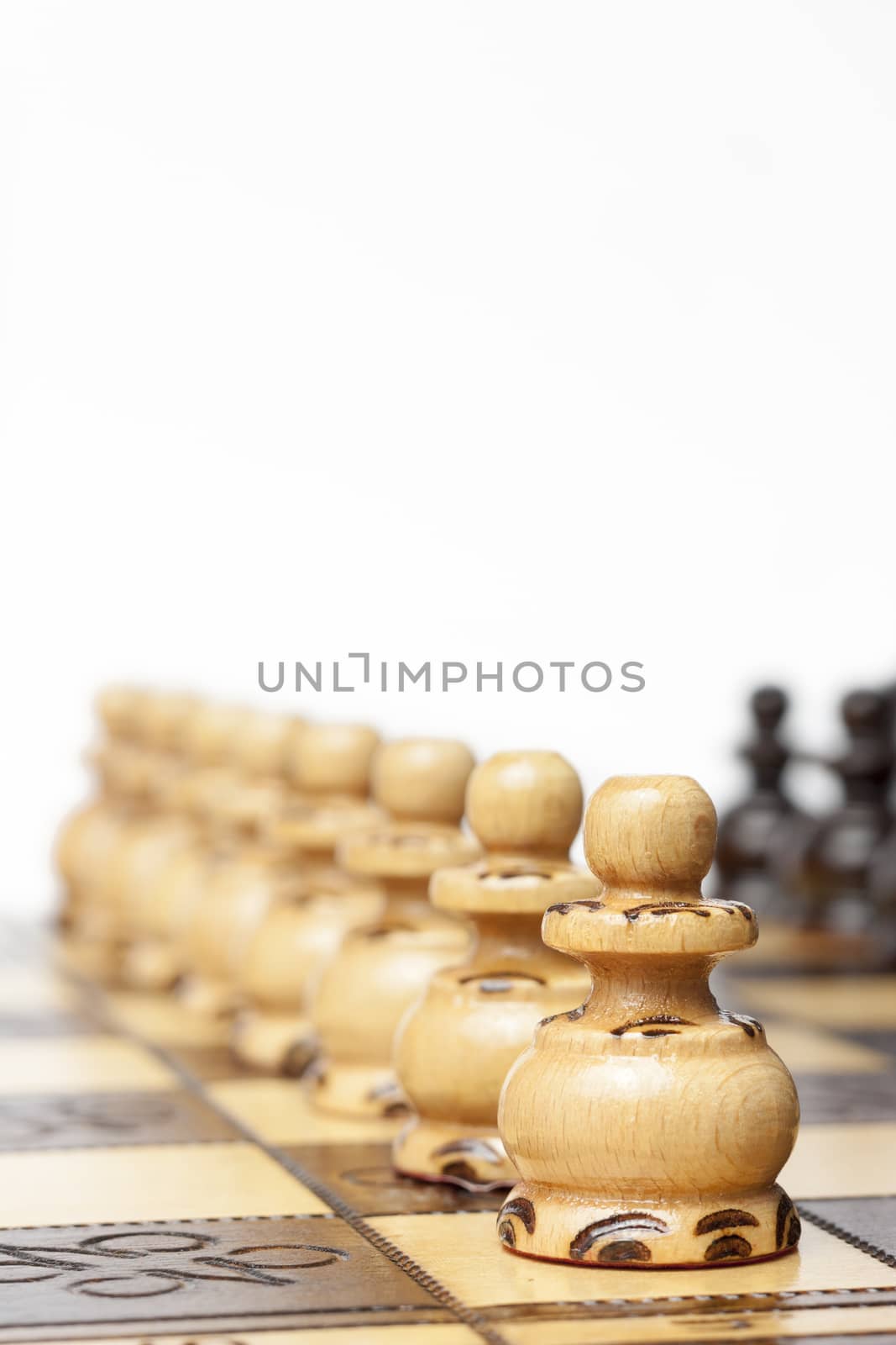 Chess pawns in a line on the board ready for revenge. Business concept