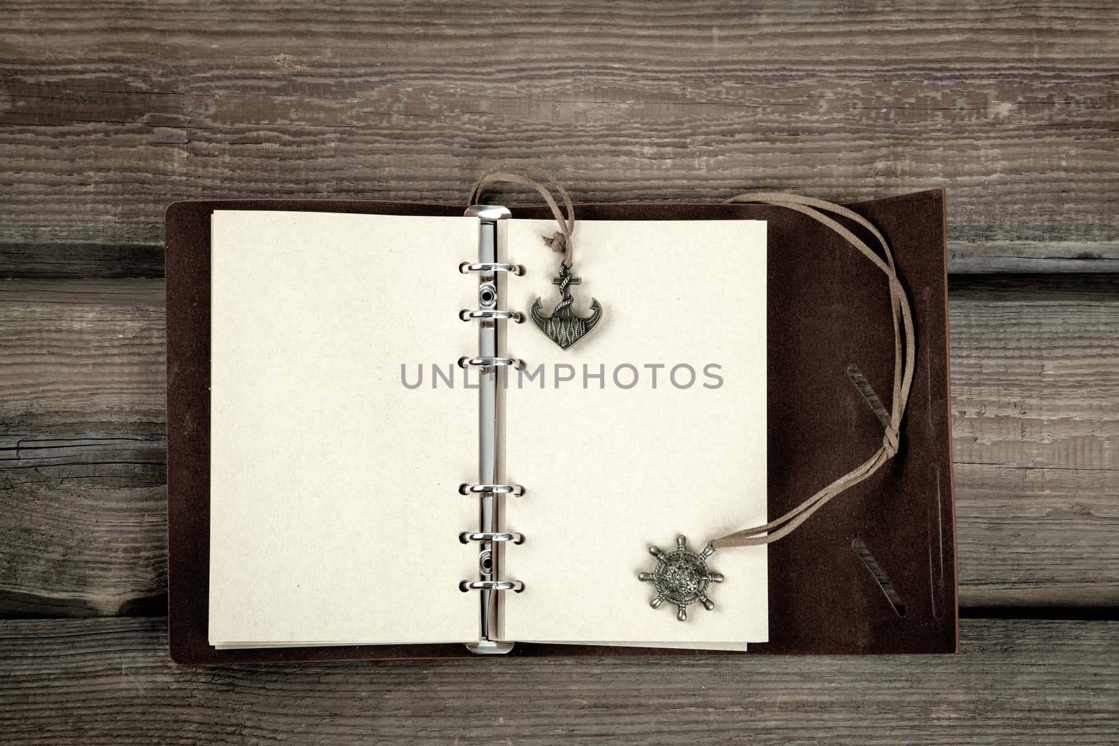 Vintage book, open, on old wooden table, with clipping path