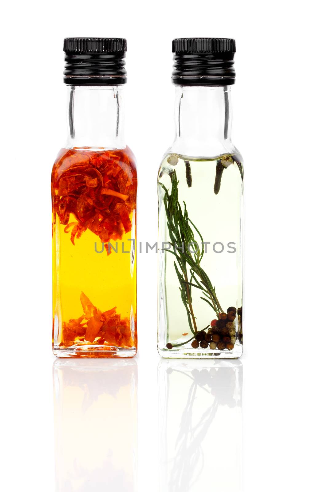 oil with rosemary and red pepper isolated on a white background. by motorolka