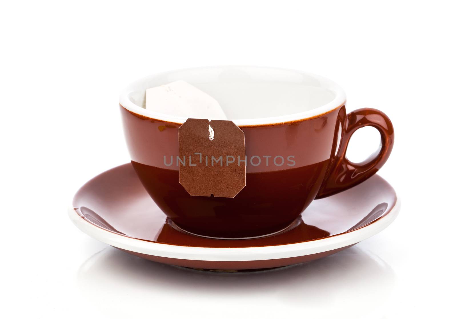 Cup of tea with tea bag (blank label) on white background by motorolka