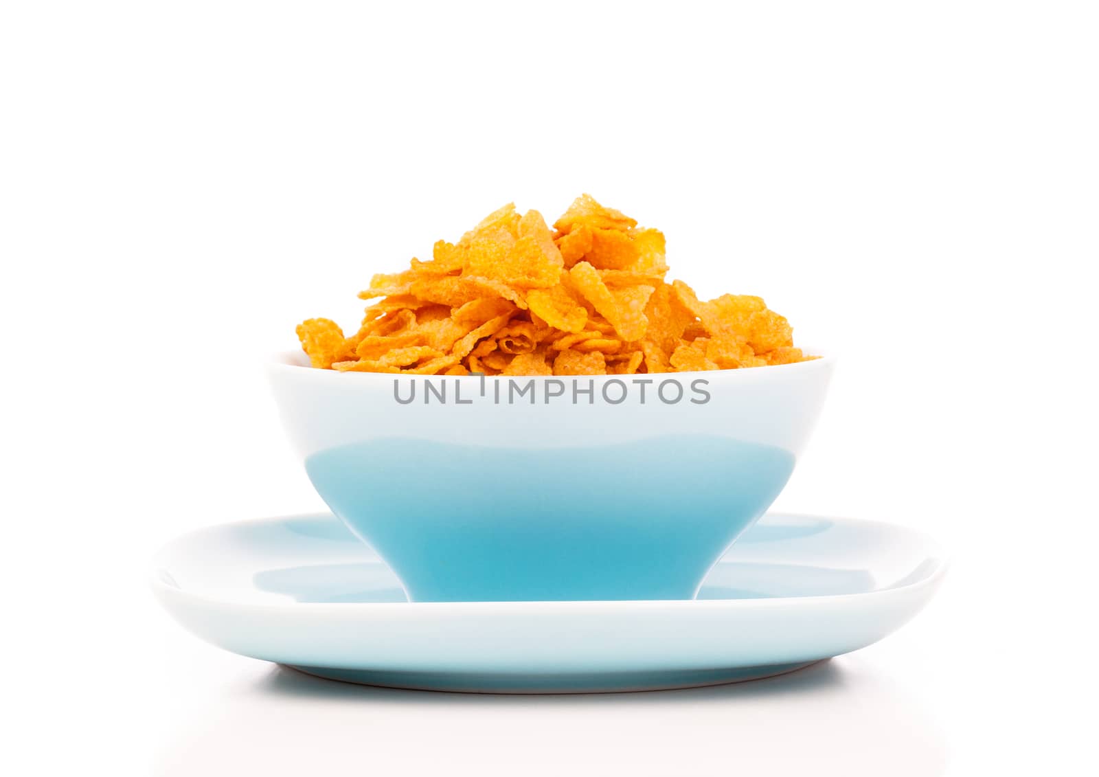 Cornflakes in porcelain bowl isolated on white background by motorolka