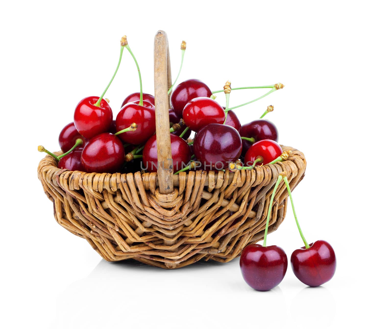 Basket full of fresh red cherry on a white background by motorolka