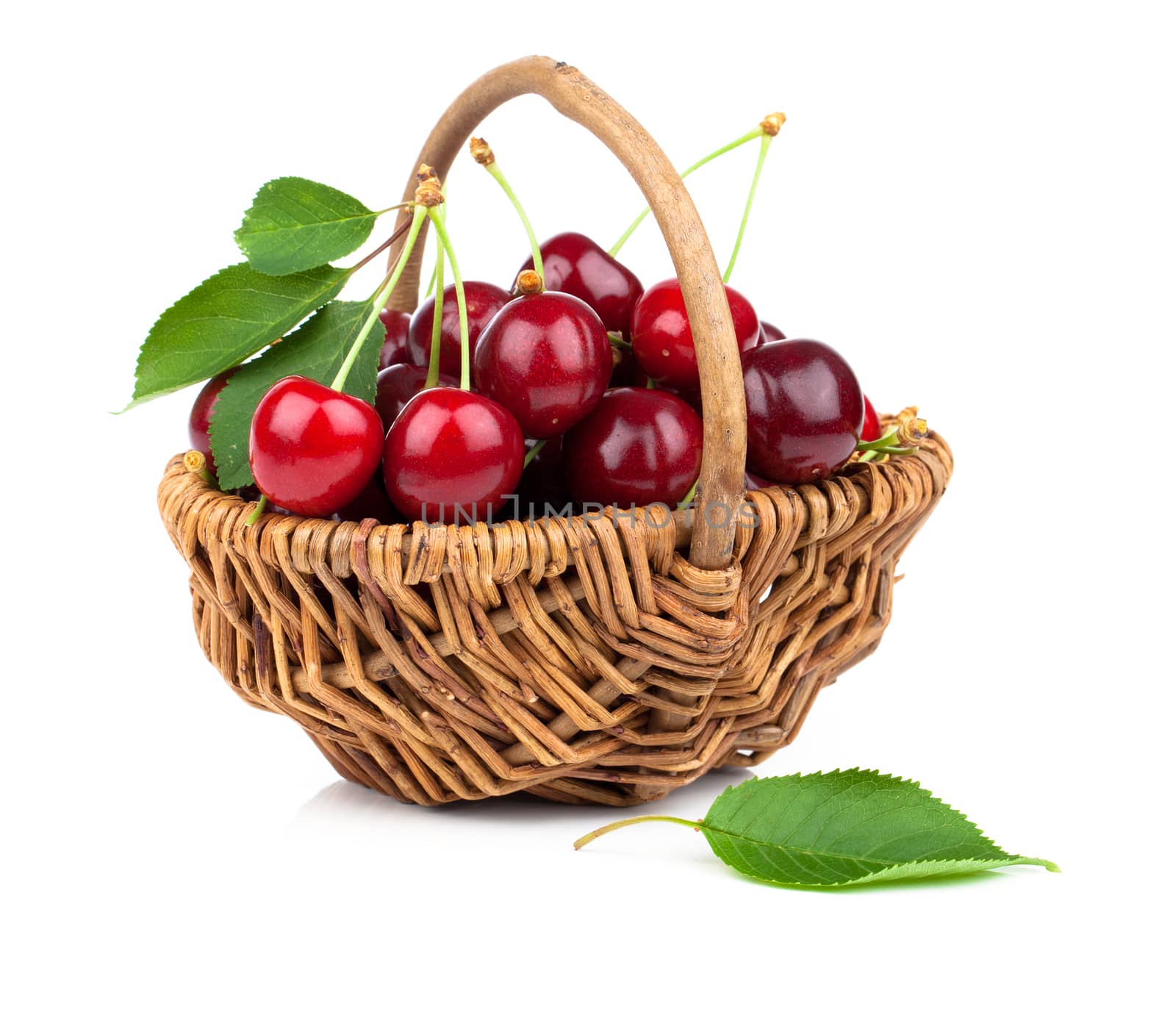 Basket full of fresh red cherry on a white background by motorolka