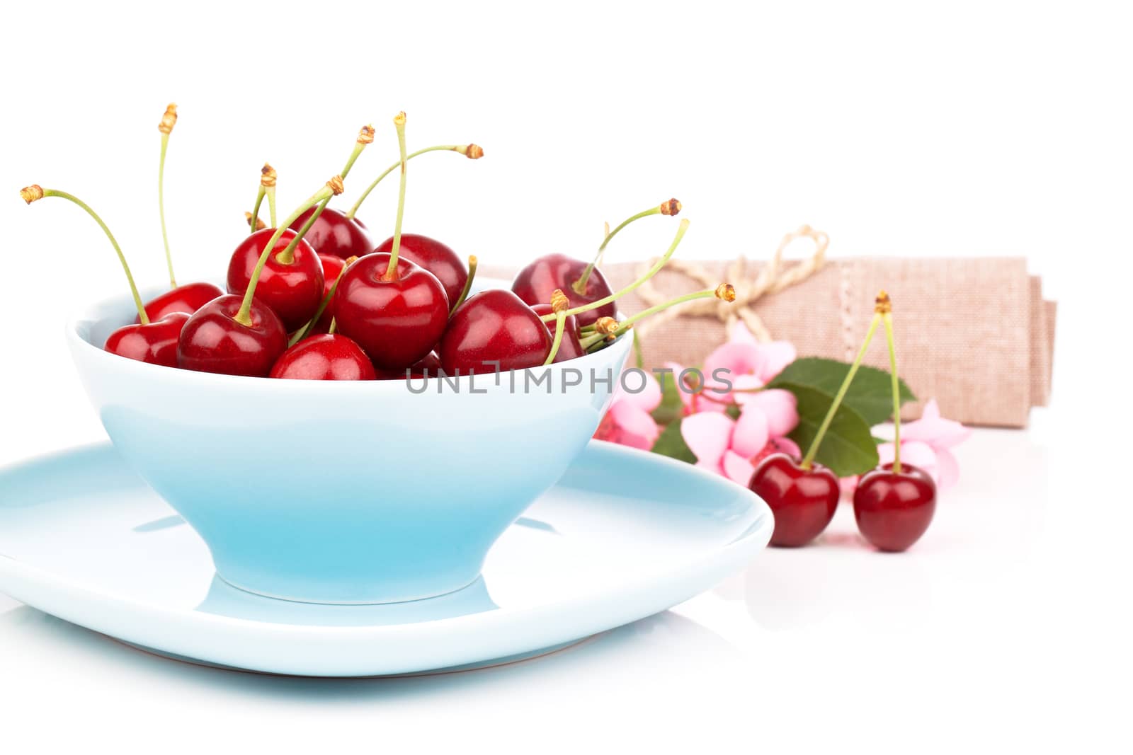 Bowl full of cherries isolated on white background