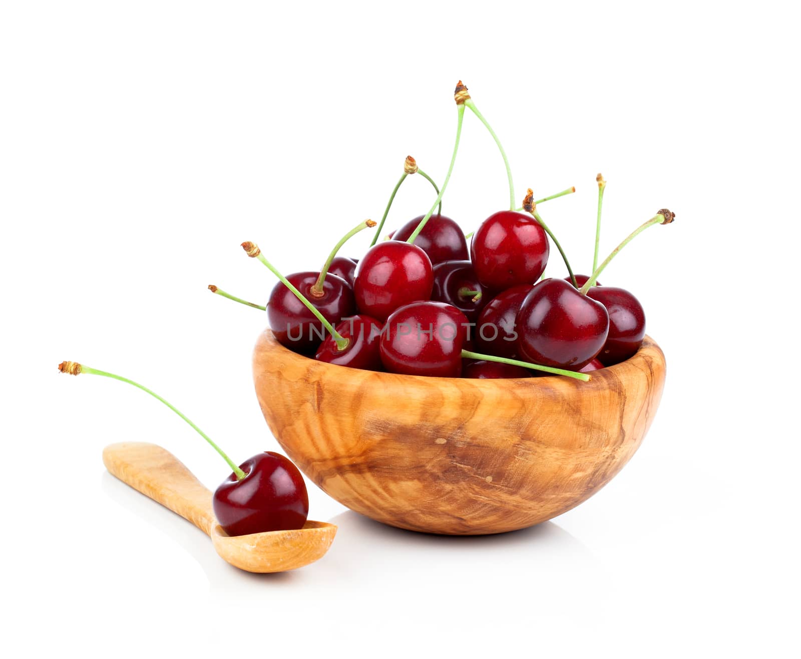 Sweet cherry in a wooden bowl, isolated on white background by motorolka