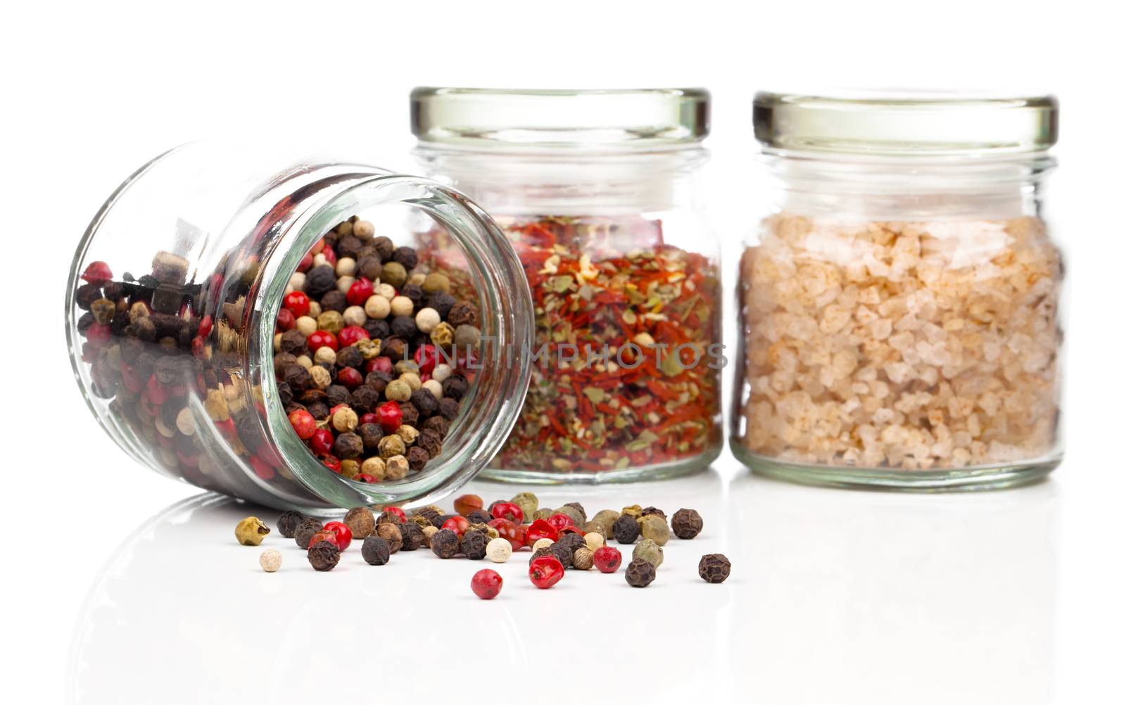 Colored Peppers Mix in a glass bottle, on the white background