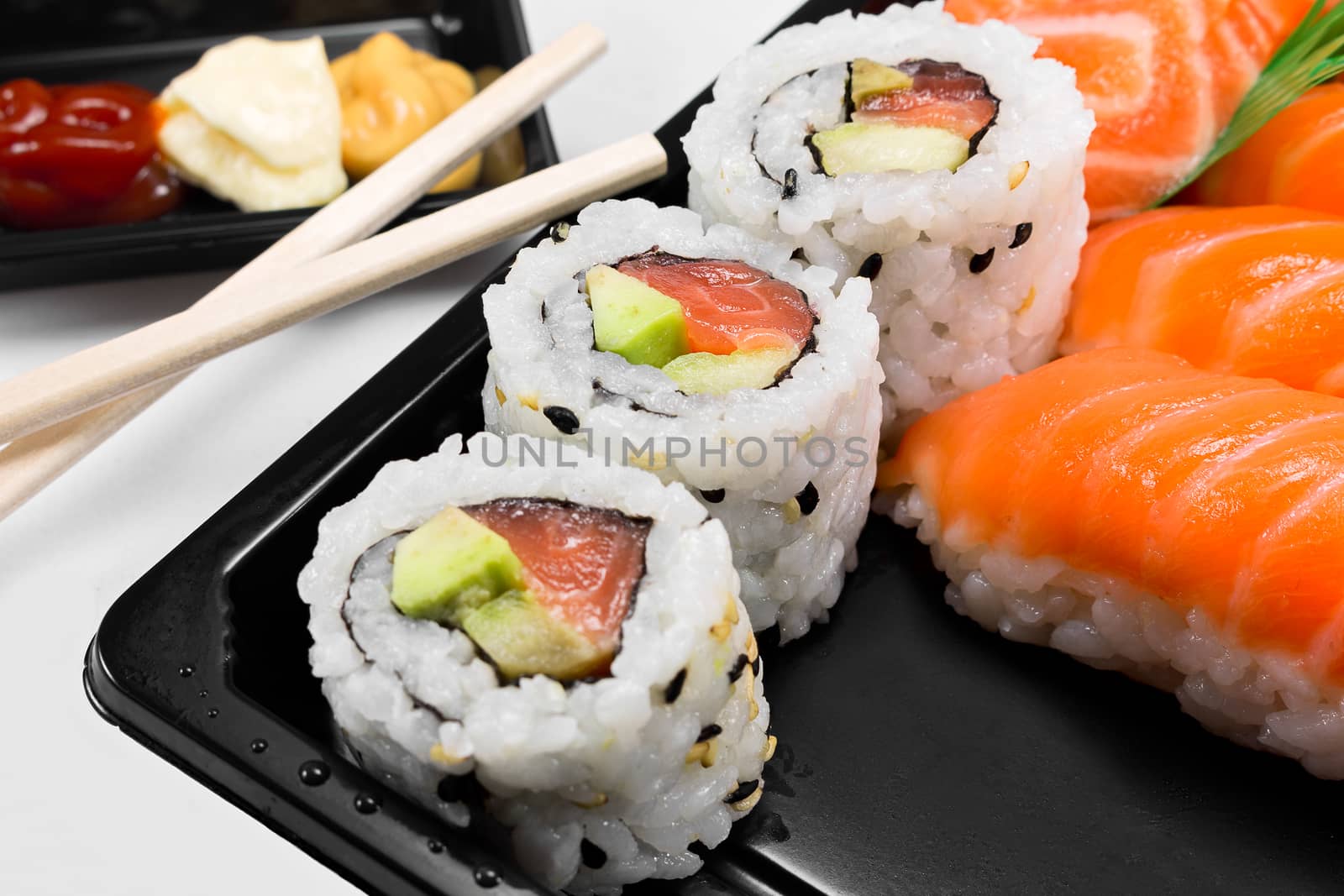 Sushi of rice and salmon with dish and chopsticks