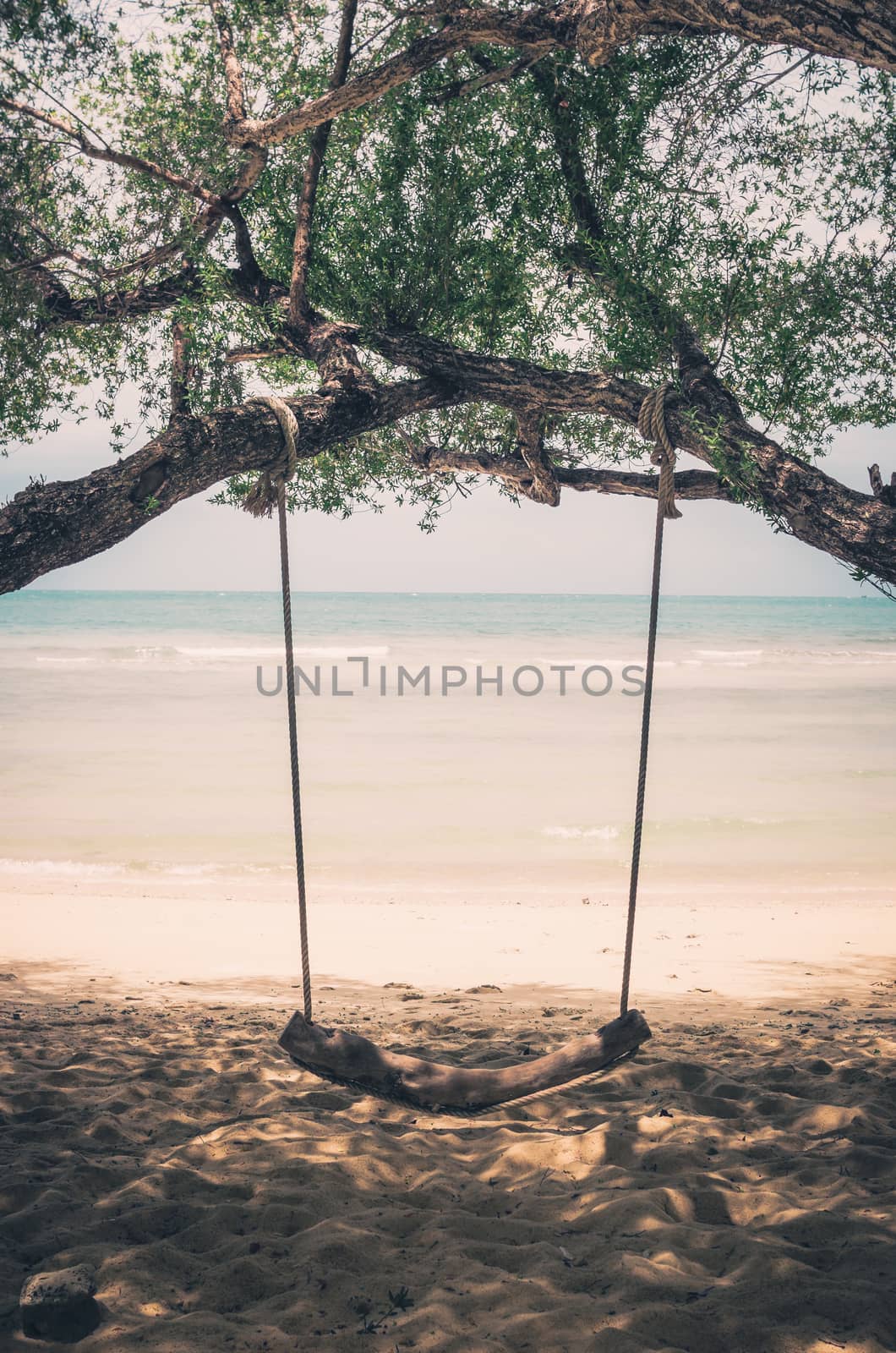 swing on beach sand and sea in Koh Samet Thailand vintage