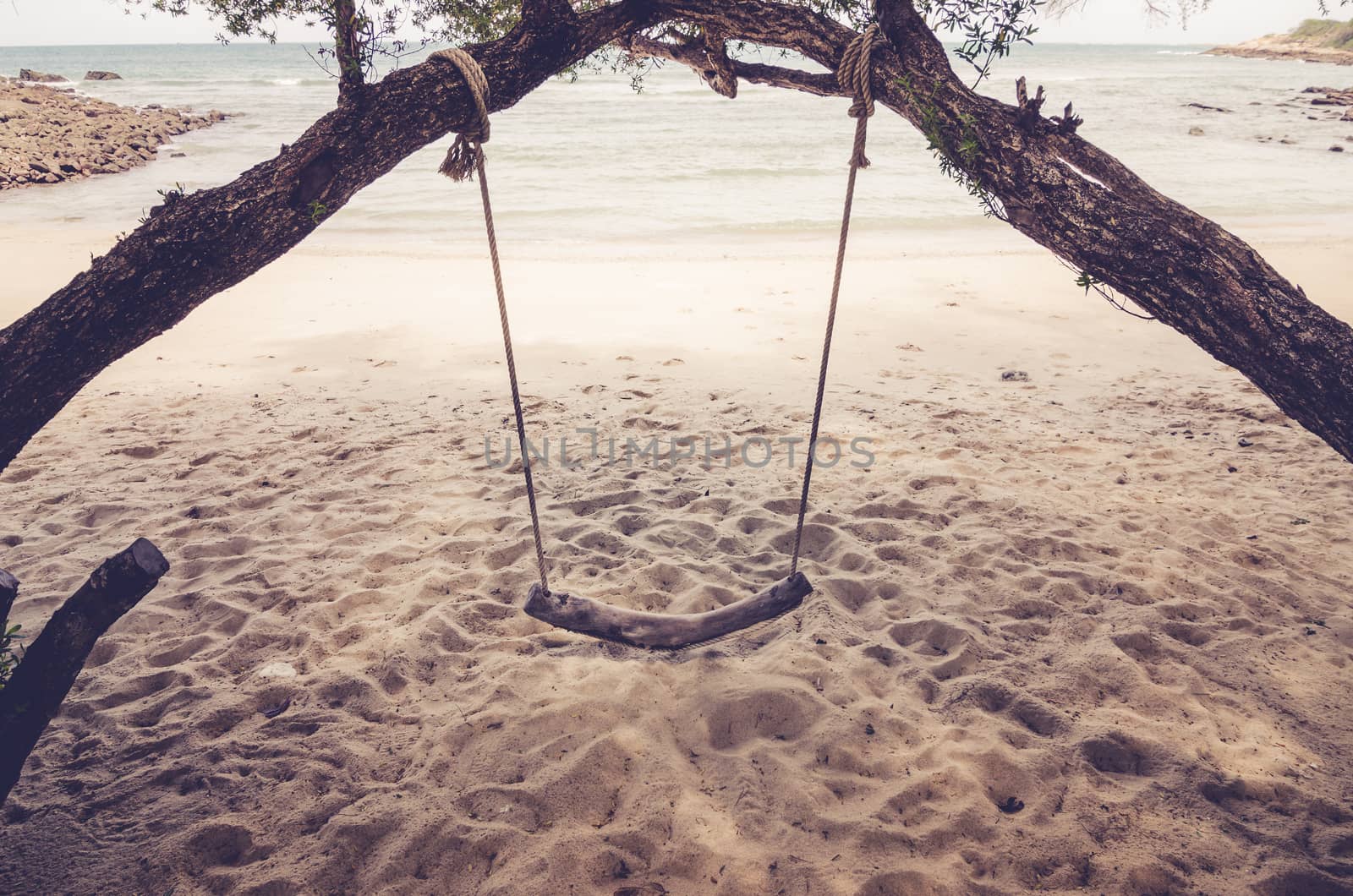 swing on beach sand and sea in Koh Samet Thailand vintage