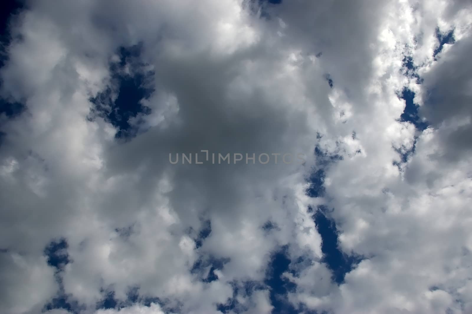 The soft white clouds against blue sky