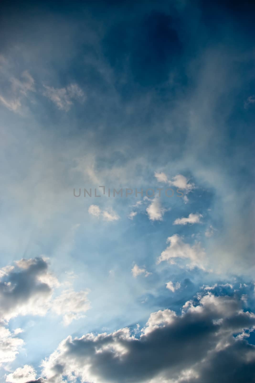 The soft white clouds against blue sky