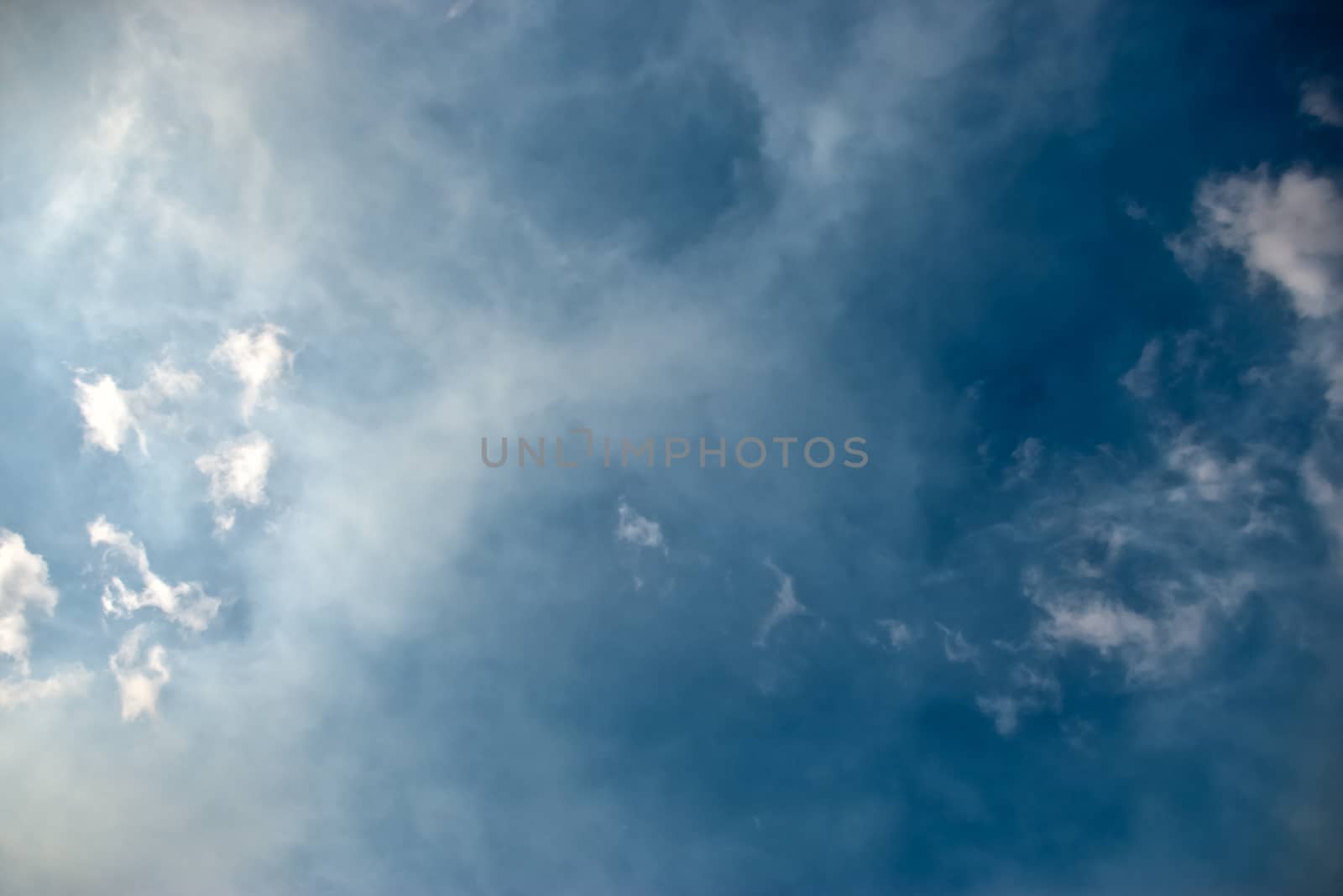 The soft white clouds against blue sky