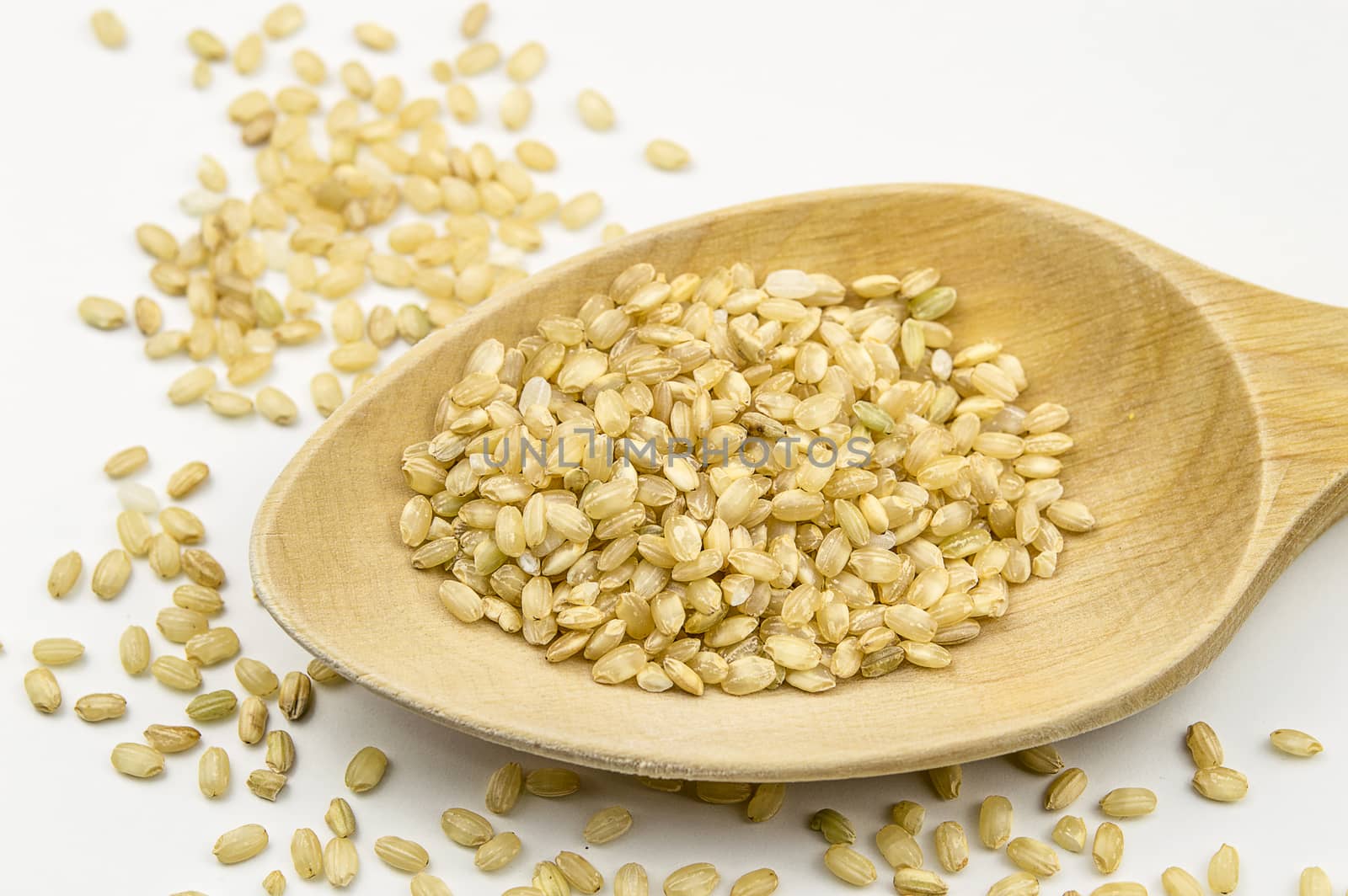 Brown rice in a wooden spoon