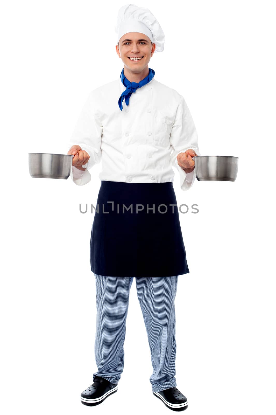 Young male chef holding empty vessels by stockyimages