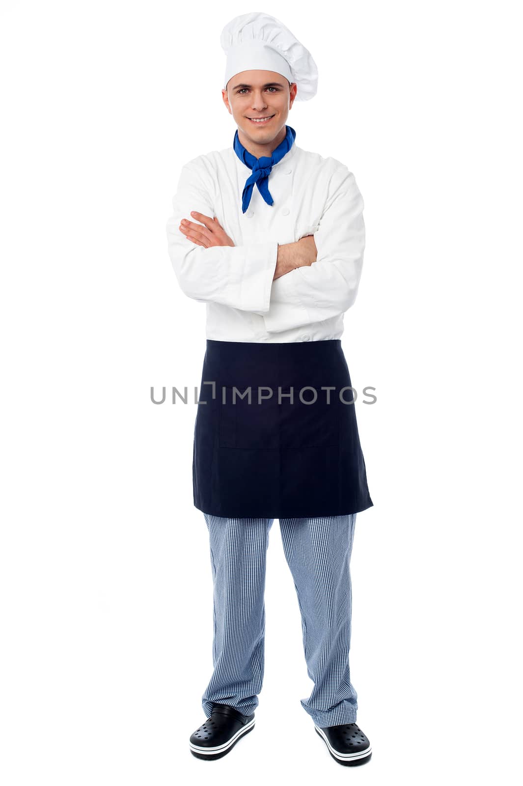 Confident young cook posing with arms crossed