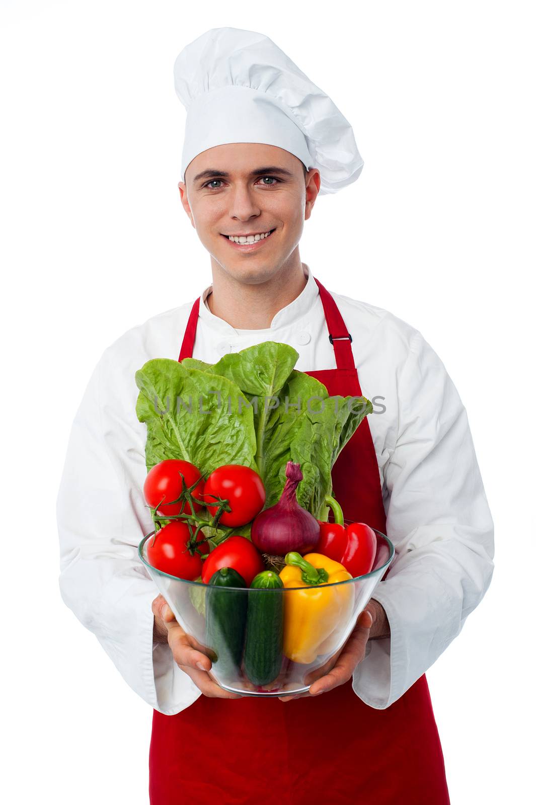 Happy chef showing vegetables in bowl isolated on white background