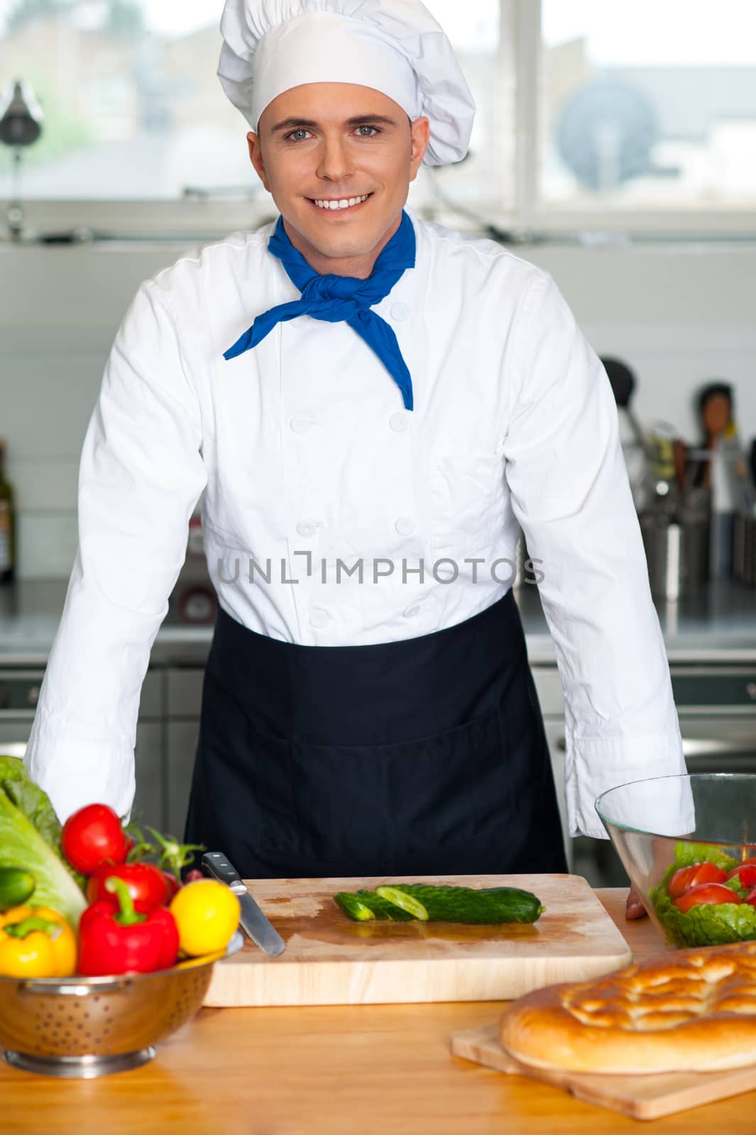 young happy man in a modern kitchen by stockyimages