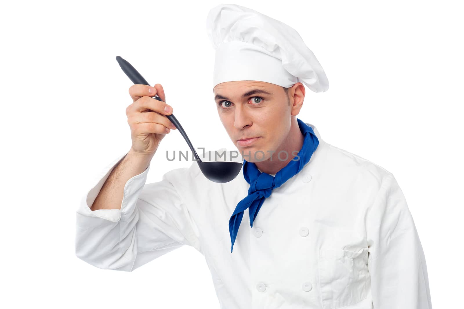 Handsome male chef tasting a dish by stockyimages