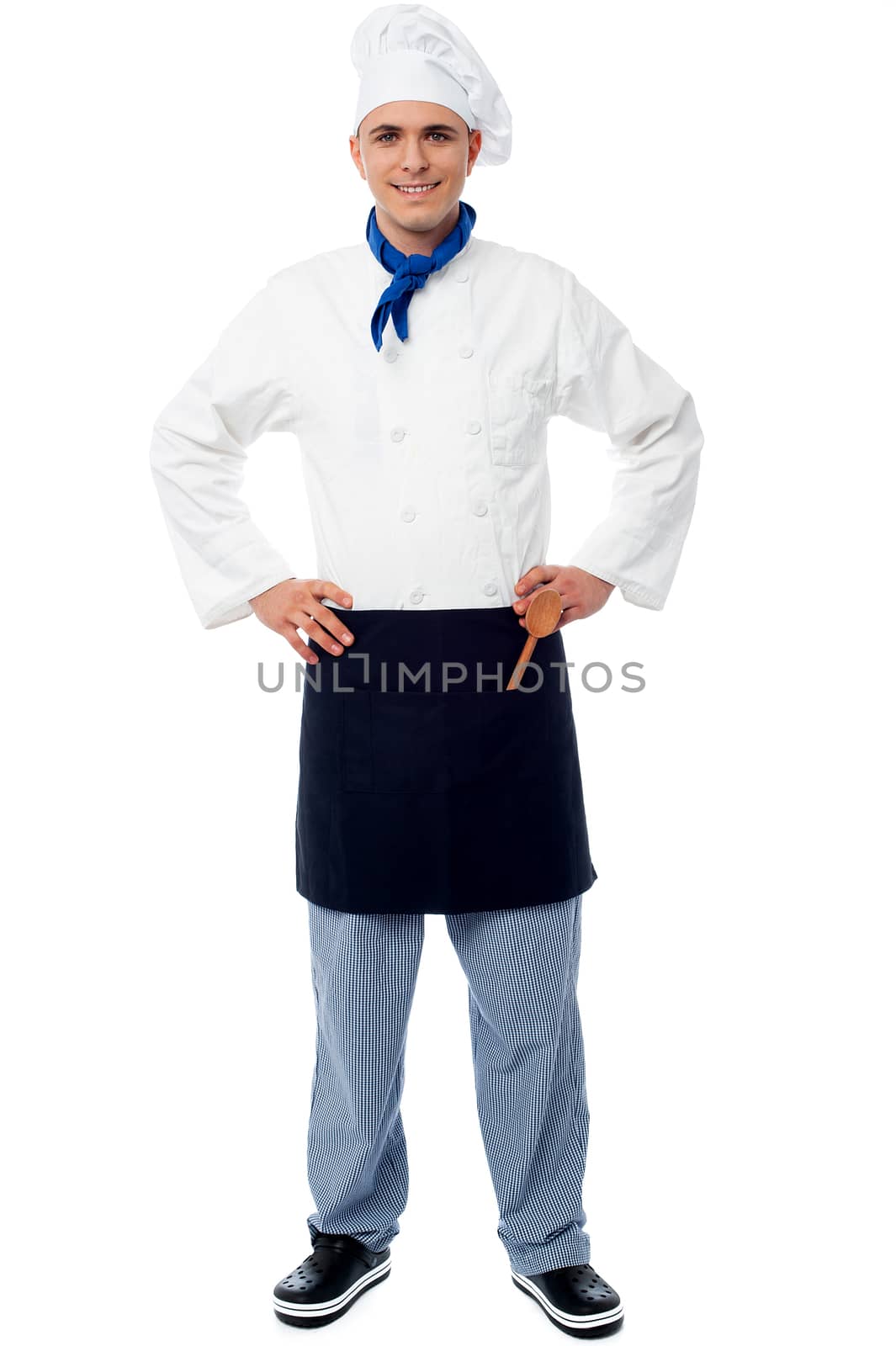 Handsome young cook posing in style over white