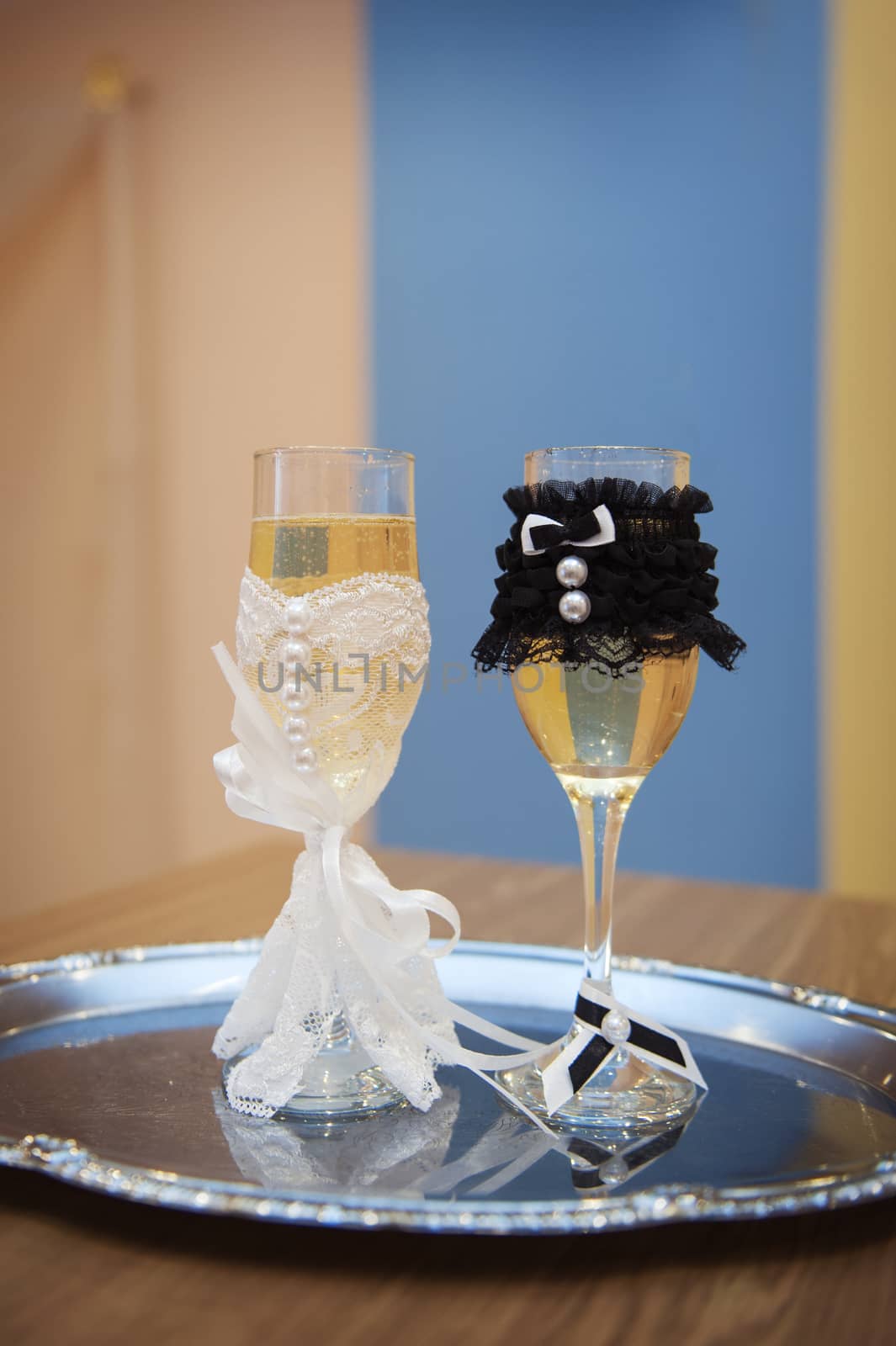 two glasses with champagne standing on the table.