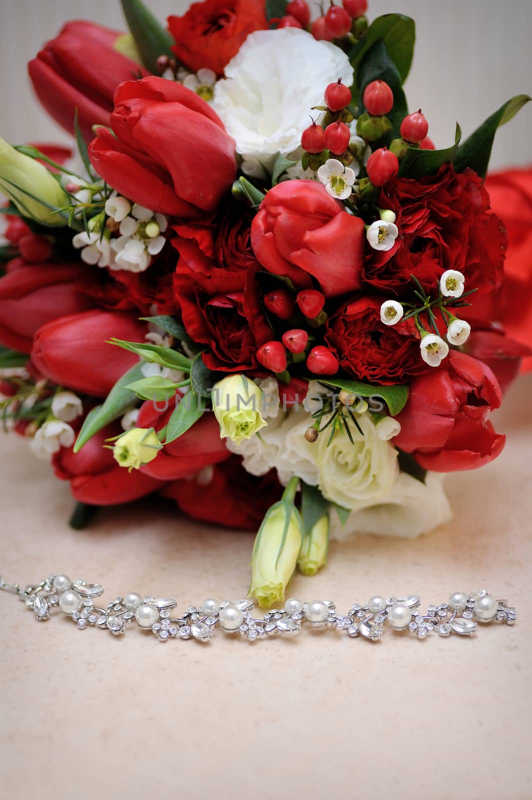 beautiful wedding bouquet and necklace on the table.