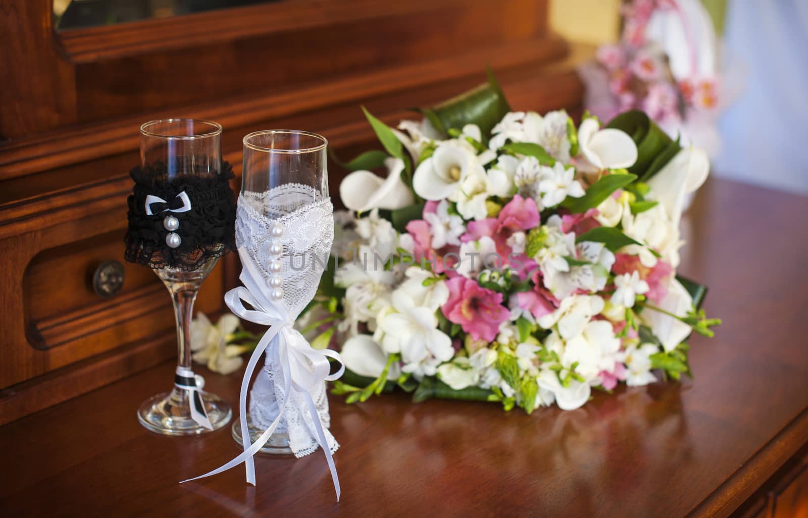 beautiful wedding bouquet and two glasses with champagne by timonko