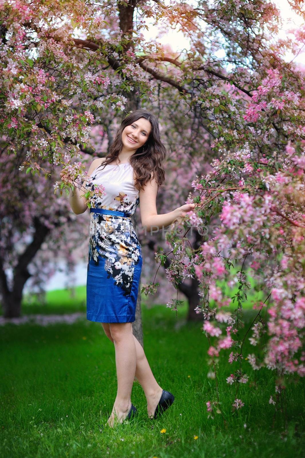 beautiful brunette woman in the park on a warm summer day.