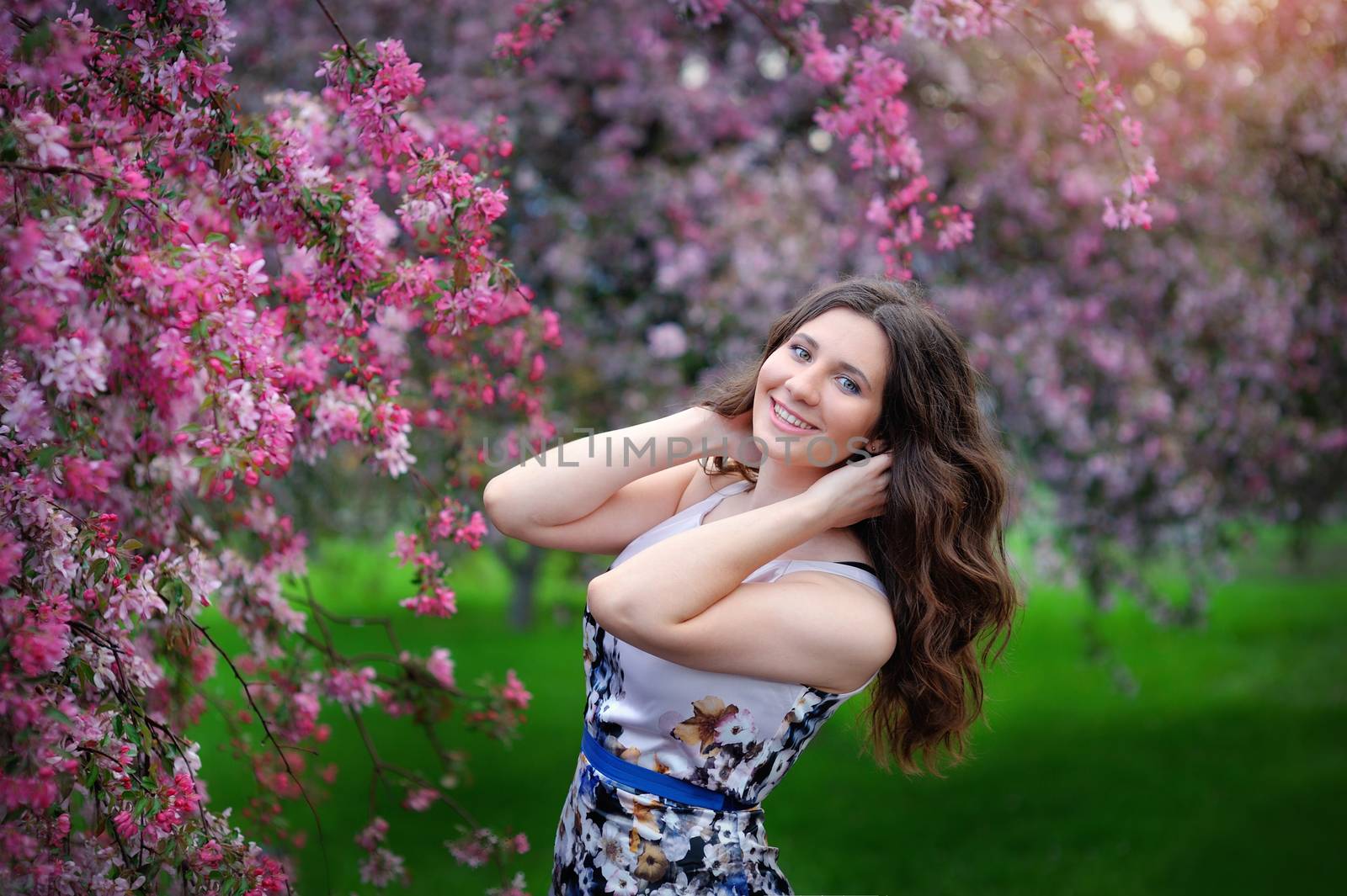 Young beautiful woman smiling at spring park.