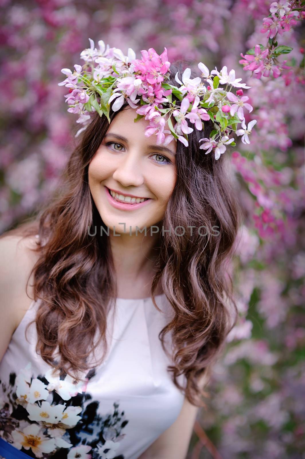 beautiful woman in the blossoming spring garden.