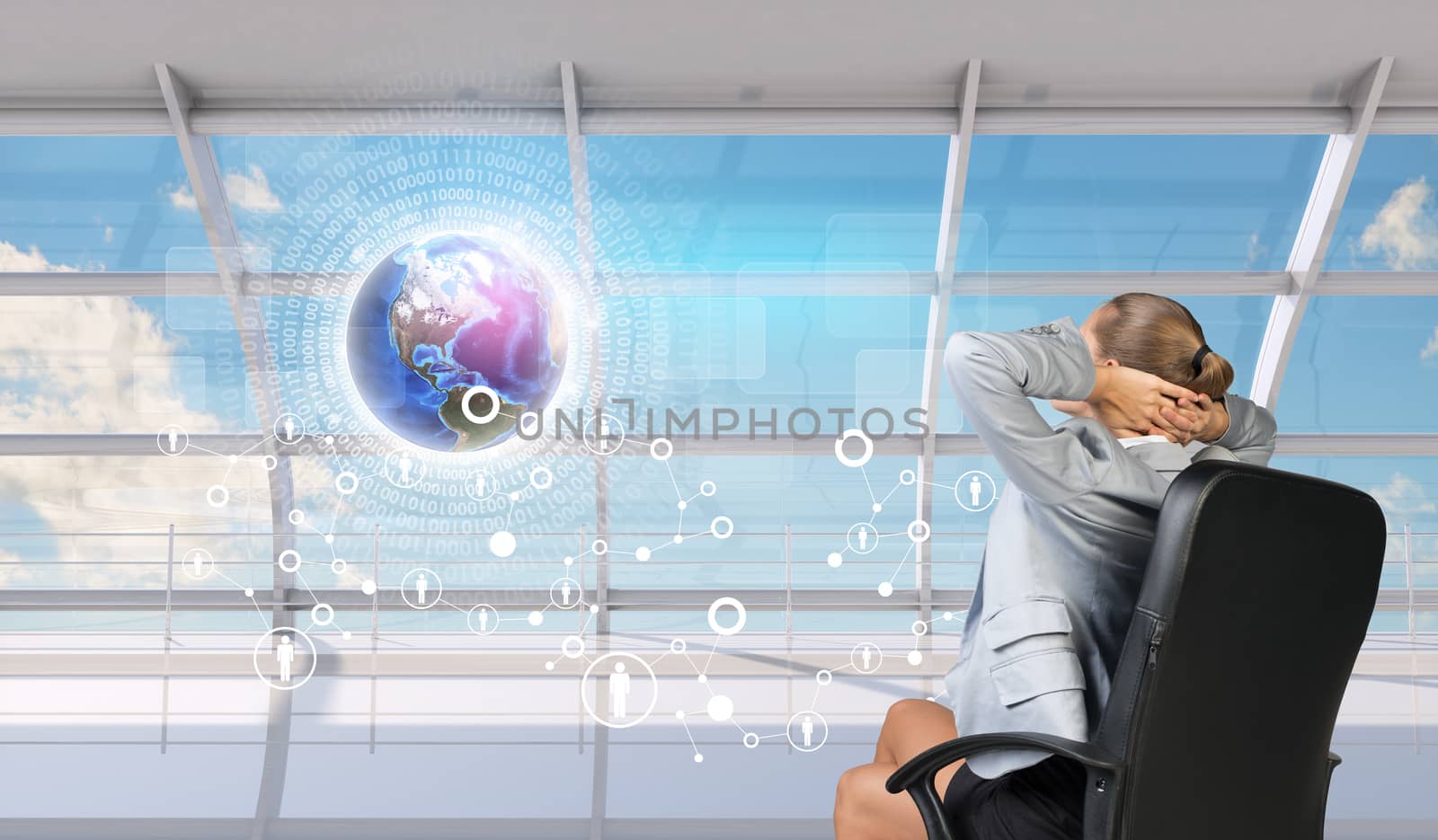 Rear view of a relaxed businesswoman with hands behind her head. Elements of this image furnished by NASA