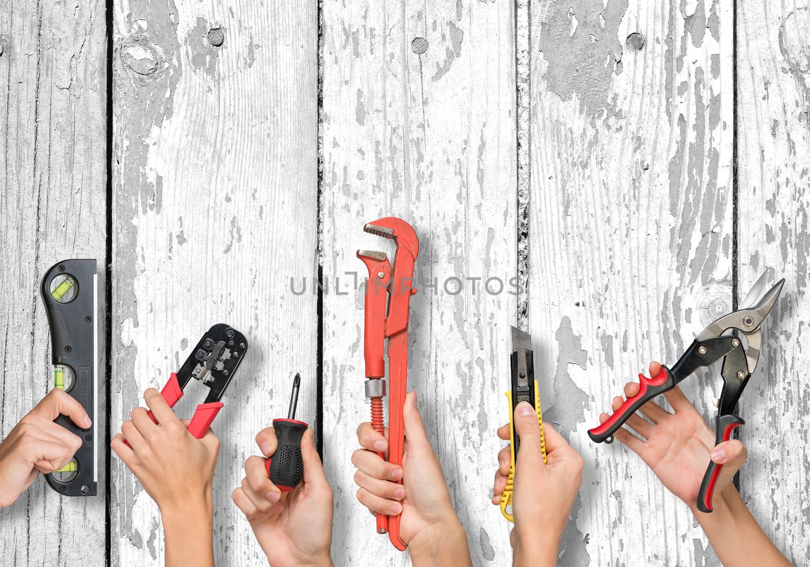 Set of peoples hands holding different tools on white board texture background