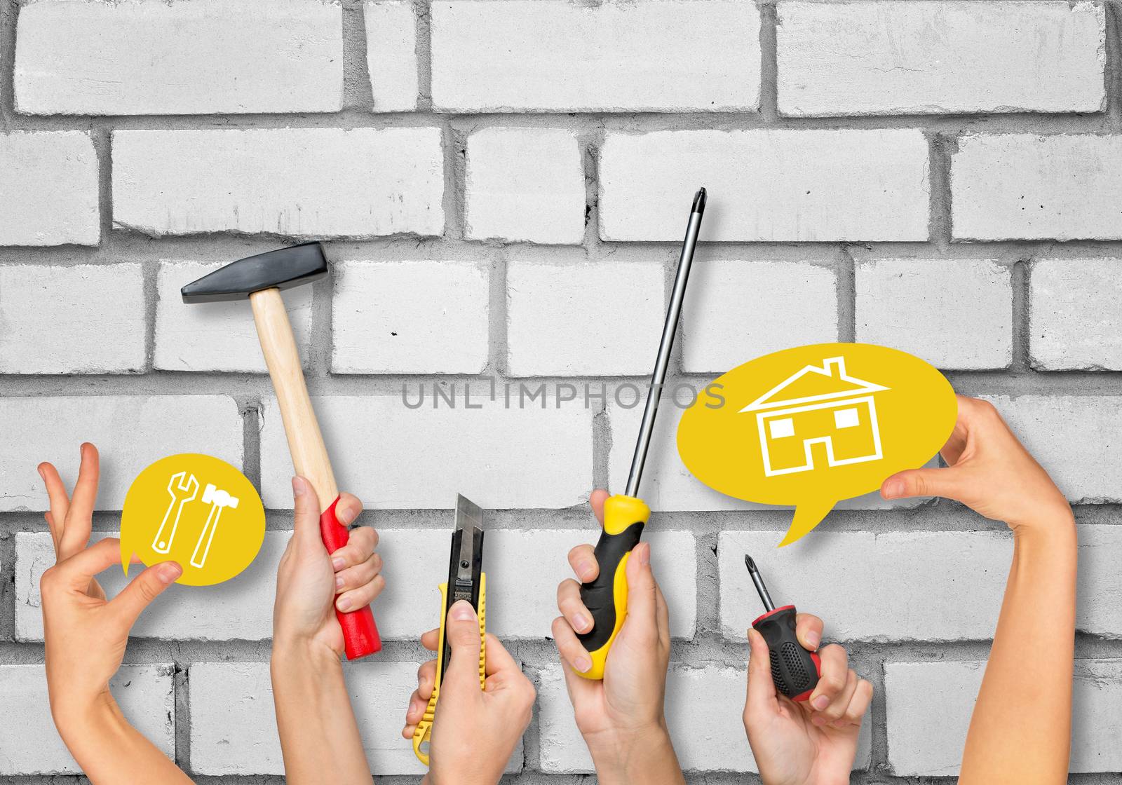 Set of peoples hands holding different tools and computer icons on white brick wall texture background