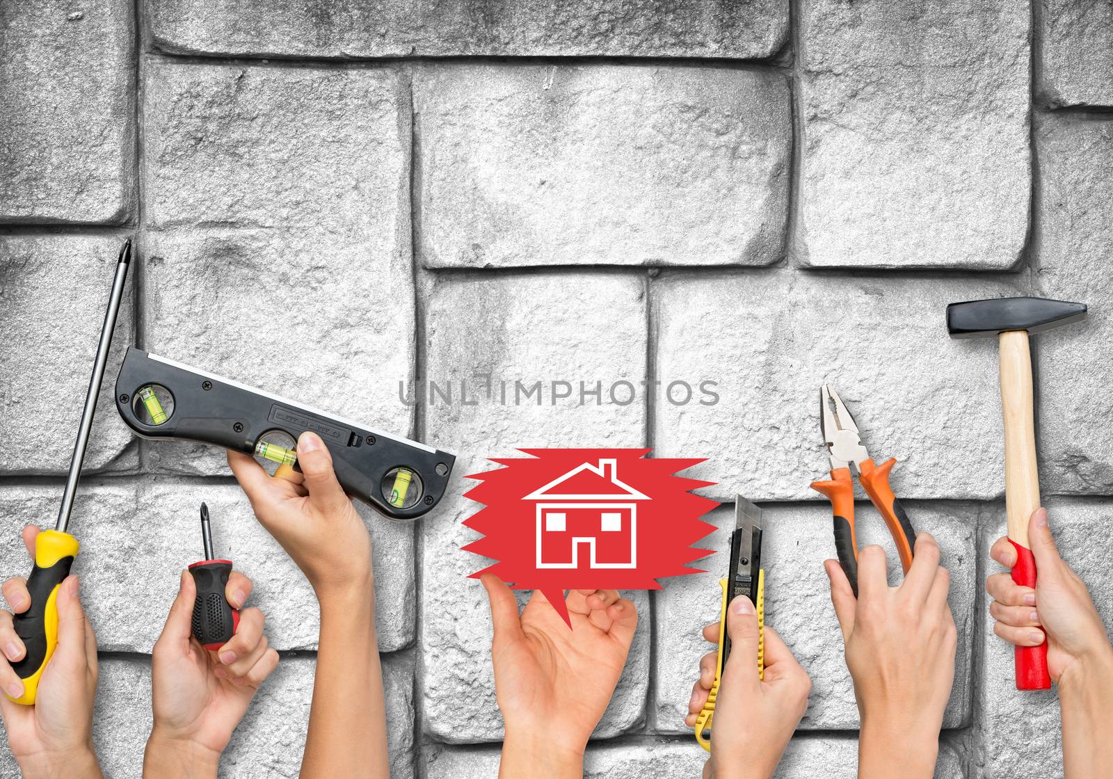 Set of peoples hands holding different tools and computer icons on old grey brick wall texture background