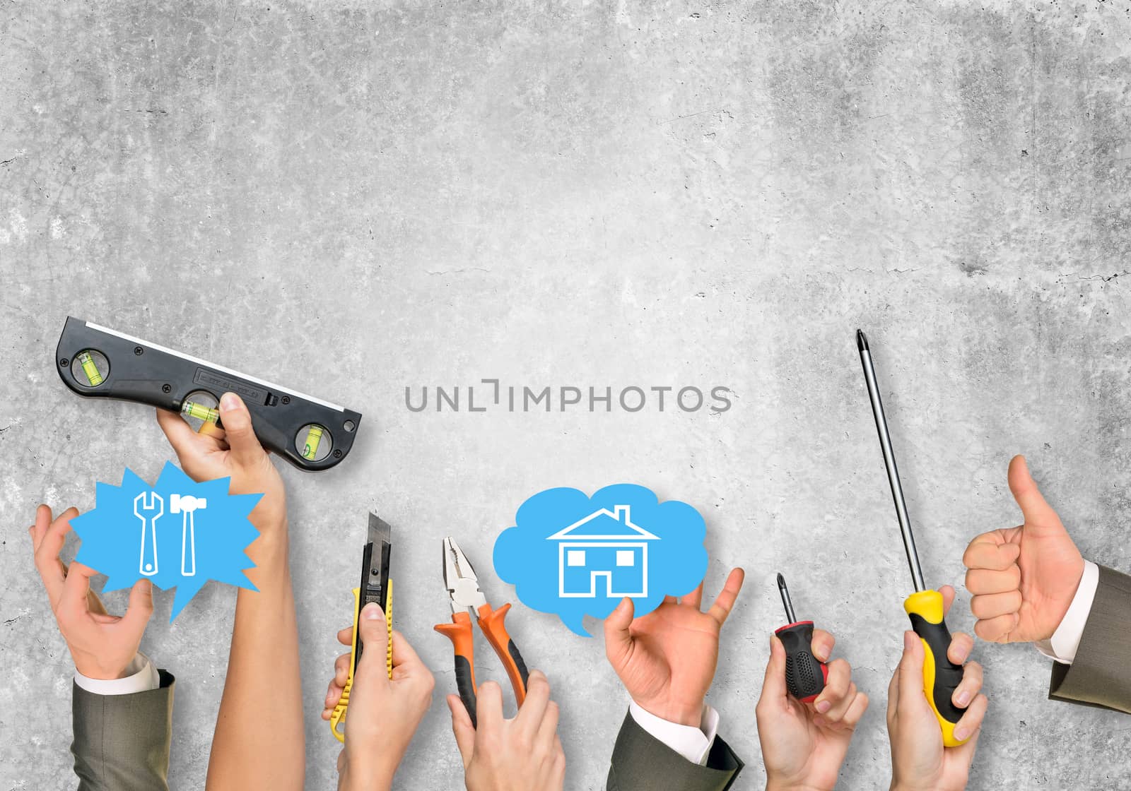 Business people hands holding computer icons on grey wall texture background