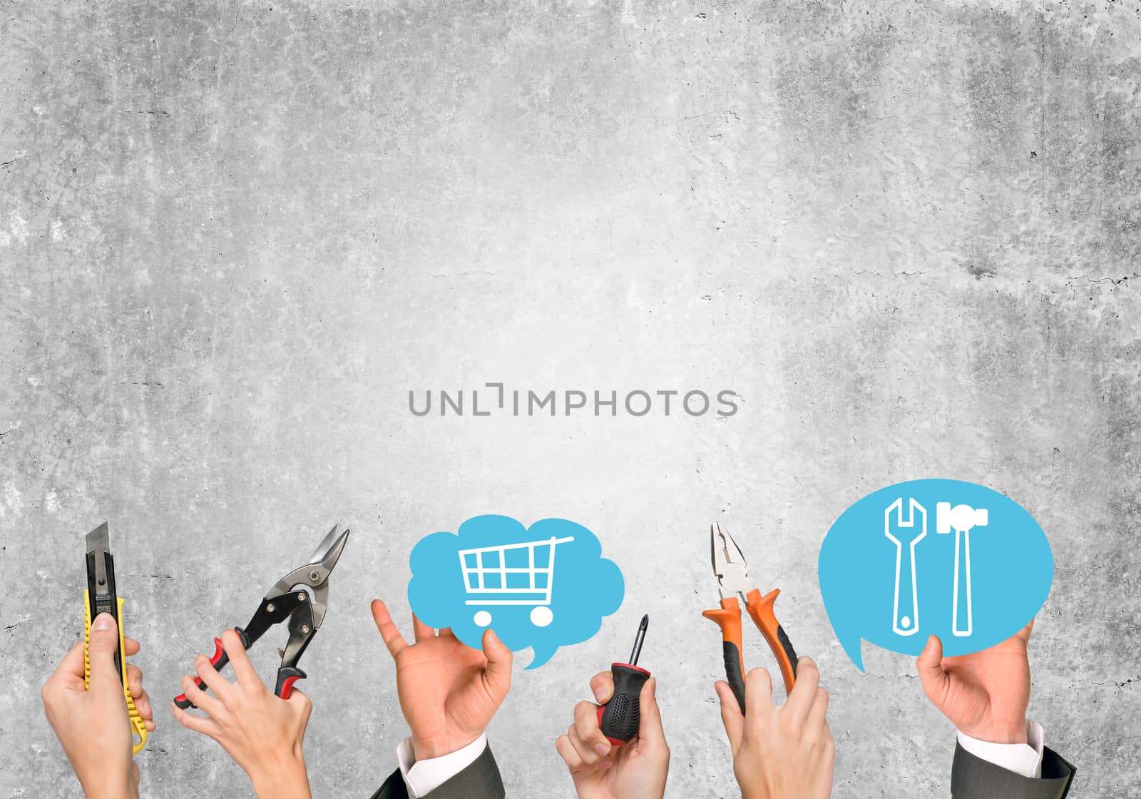 Business people hands holding computer icons on old grey wall texture background