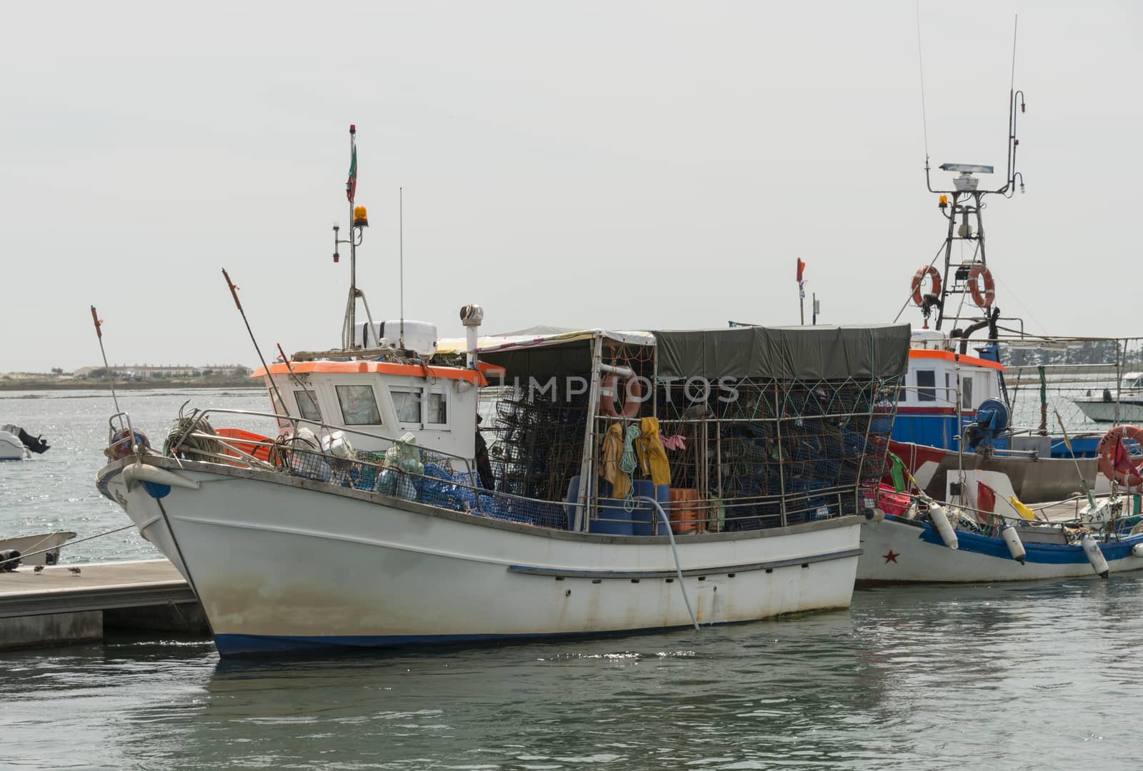fishing boat with nets in portugal by compuinfoto