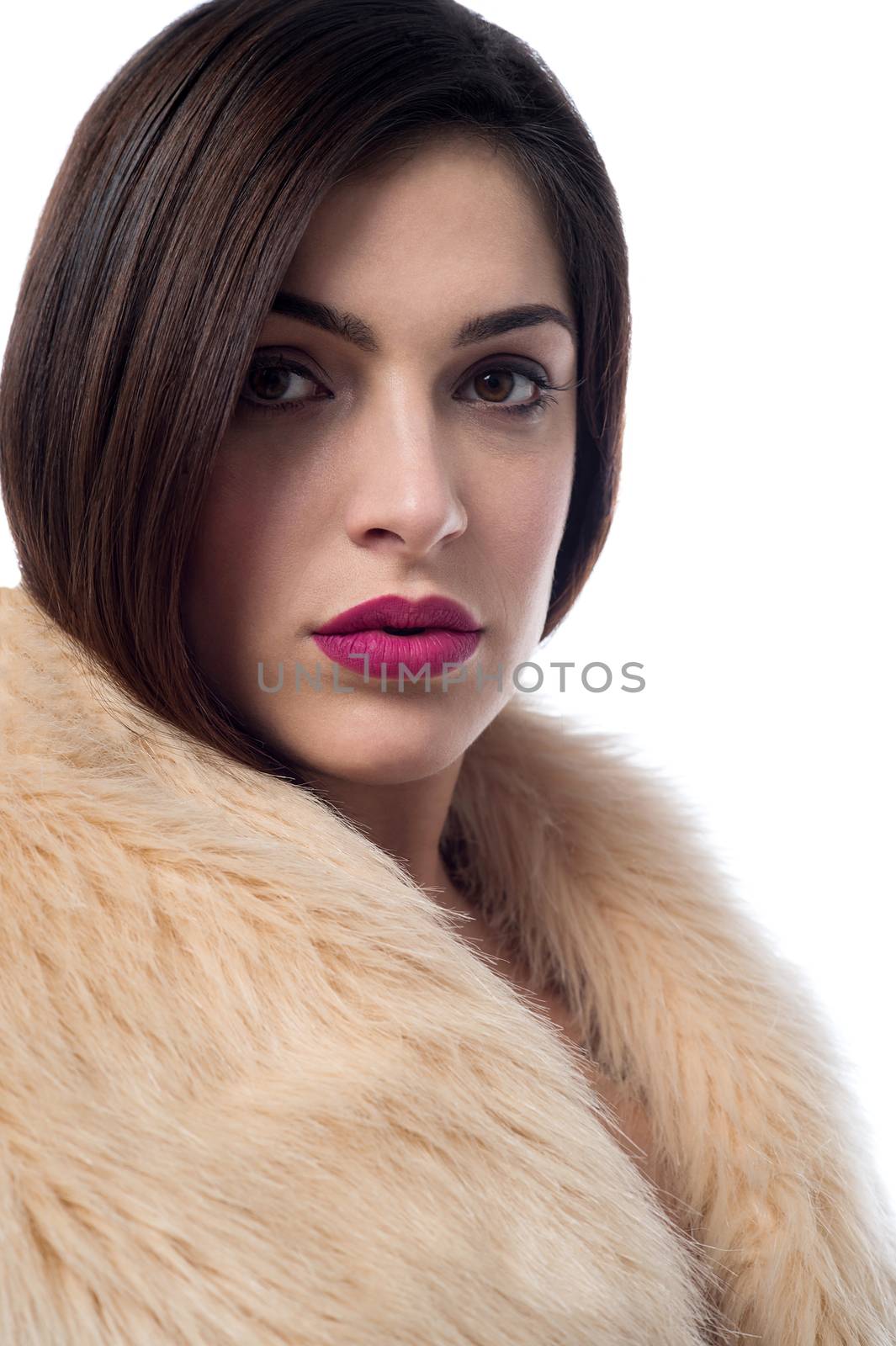 Stylish young woman in fur coat by stockyimages