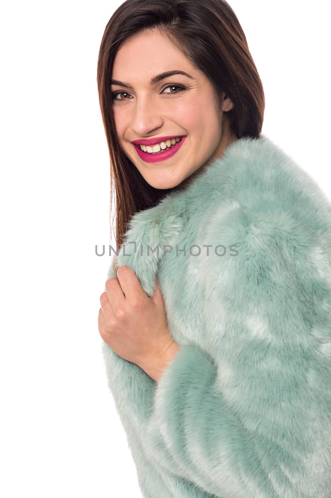 Beautiful young woman in a luxurious fur coat