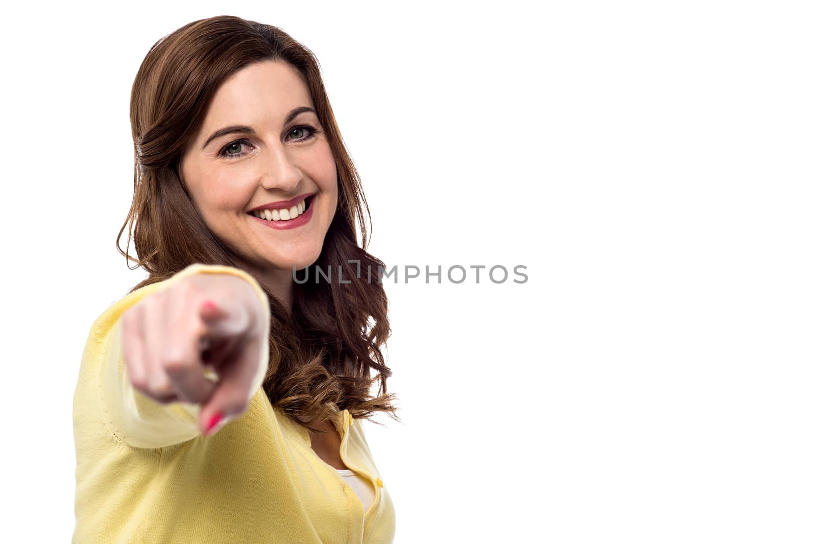 Cheerful woman pointing towards you