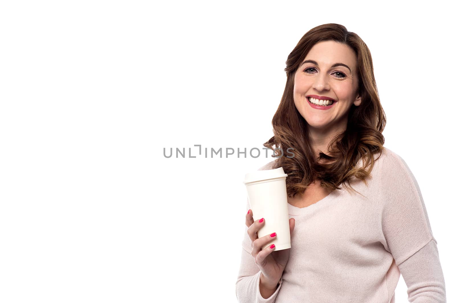 Smiling woman posing with paper coffee cup