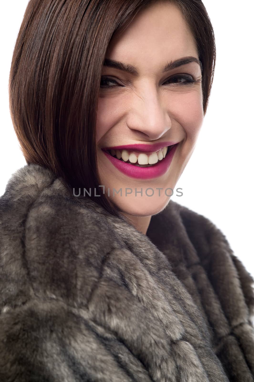 Closeup image of young woman in fur coat